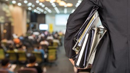 Businessman is holding many document folders